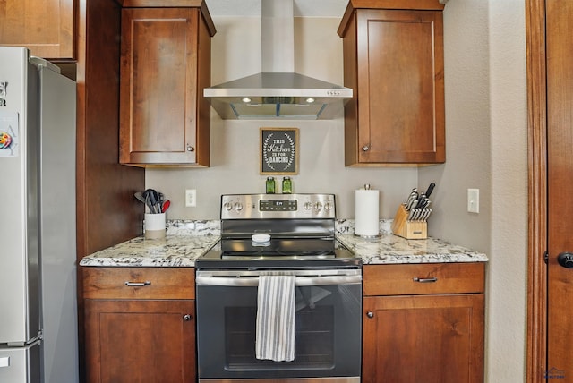 4528 Lahinch St, Rapid City, SD 57702 - kitchen with stainless steel appliances, wall chimney exhaust hood, light stone counters, and brown cabinets