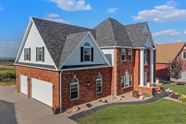 1120 S Regency Ct, Rapid City, SD 57702 - view of front of house featuring driveway, a garage, brick siding, a front lawn, and roof with shingles