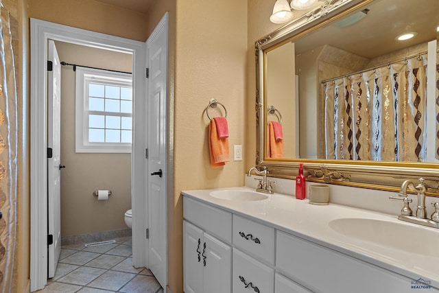 1120 S Regency Ct, Rapid City, SD 57702 - bathroom with double vanity, toilet, and tile patterned floors
