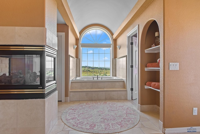1120 S Regency Ct, Rapid City, SD 57702 - full bath featuring tile patterned flooring, a bath, a textured wall, lofted ceiling, and baseboards