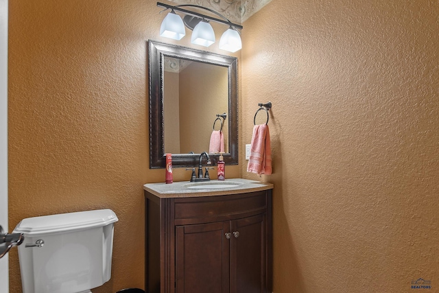 1120 S Regency Ct, Rapid City, SD 57702 - half bath with a textured wall, vanity, and toilet