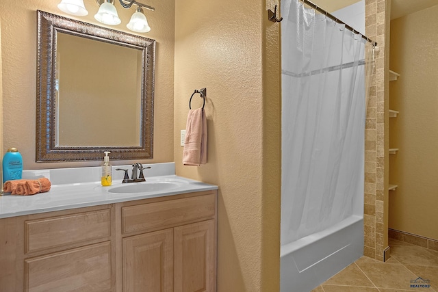 1120 S Regency Ct, Rapid City, SD 57702 - bathroom featuring vanity, shower / tub combo with curtain, tile patterned floors, and a textured wall