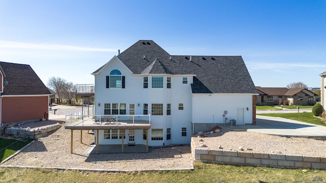 1120 S Regency Ct, Rapid City, SD 57702 - back of house with a patio area, a deck, roof with shingles, a balcony, and concrete driveway