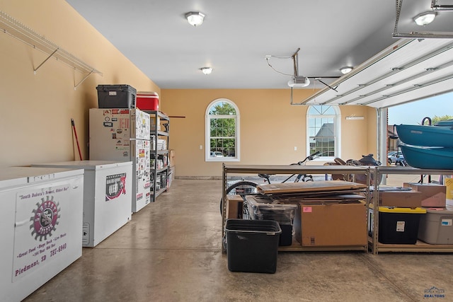 1120 S Regency Ct, Rapid City, SD 57702 - garage with freestanding refrigerator and a garage door opener