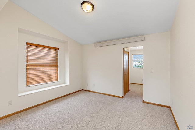768 Earleen St Unit F, Rapid City, SD 57701 - unfurnished room with lofted ceiling, baseboards, and carpet floors
