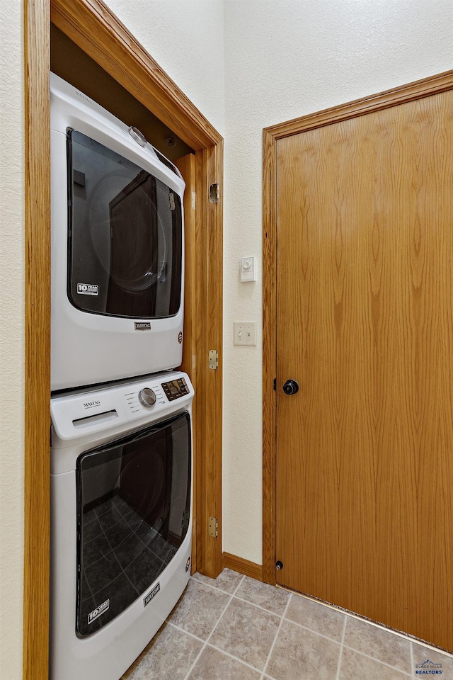 768 Earleen St Unit F, Rapid City, SD 57701 - laundry room featuring stacked washer / drying machine and baseboards