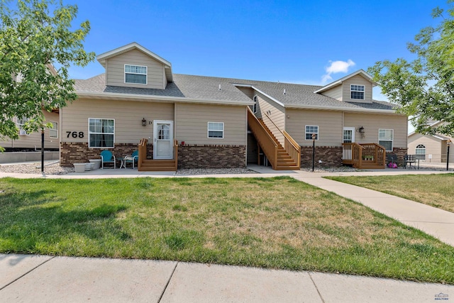 768 Earleen St Unit F, Rapid City, SD 57701 - view of front facade featuring brick siding, a front yard, entry steps, and a shingled roof