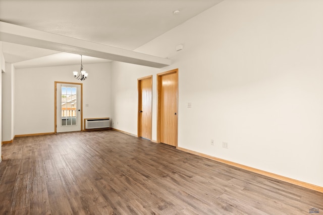 768 Earleen St Unit F, Rapid City, SD 57701 - empty room featuring a chandelier, vaulted ceiling, wood finished floors, baseboards, and baseboard heating