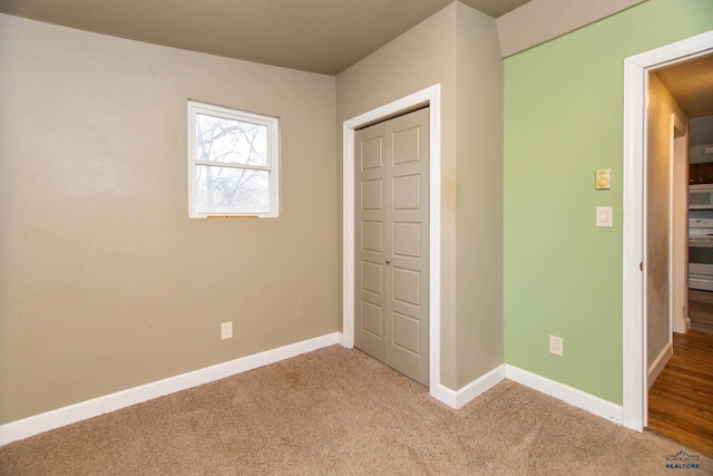 830 Willsie Ave, Rapid City, SD 57701 - unfurnished bedroom with baseboards, light colored carpet, and a closet