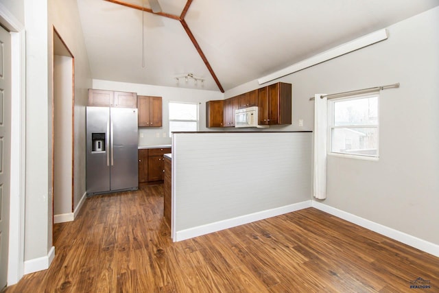 830 Willsie Ave, Rapid City, SD 57701 - kitchen featuring stainless steel fridge with ice dispenser, white microwave, lofted ceiling, dark wood-style flooring, and healthy amount of natural light