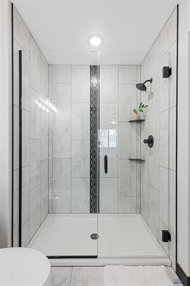 1246 Pinnacle Ct, Rapid City, SD 57701 - full bathroom featuring a shower stall, marble finish flooring, and toilet