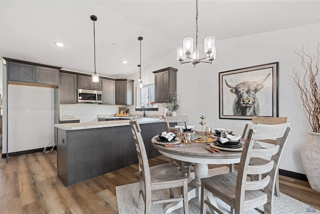 1246 Pinnacle Ct, Rapid City, SD 57701 - dining space with dark wood-style floors, a chandelier, recessed lighting, and lofted ceiling