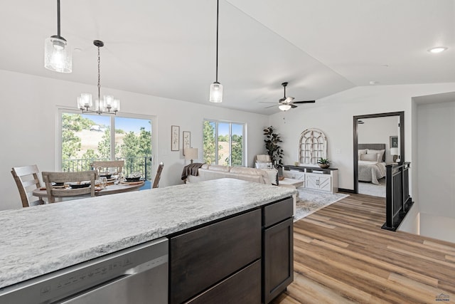 1246 Pinnacle Ct, Rapid City, SD 57701 - kitchen with stainless steel dishwasher, light wood-style floors, vaulted ceiling, a chandelier, and light countertops