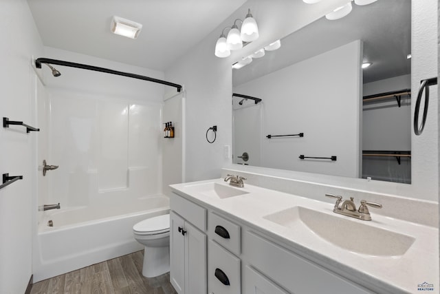 1740 Harmony Heights Ln, Rapid City, SD 57702 - bathroom featuring toilet,  shower combination, double vanity, and wood finished floors