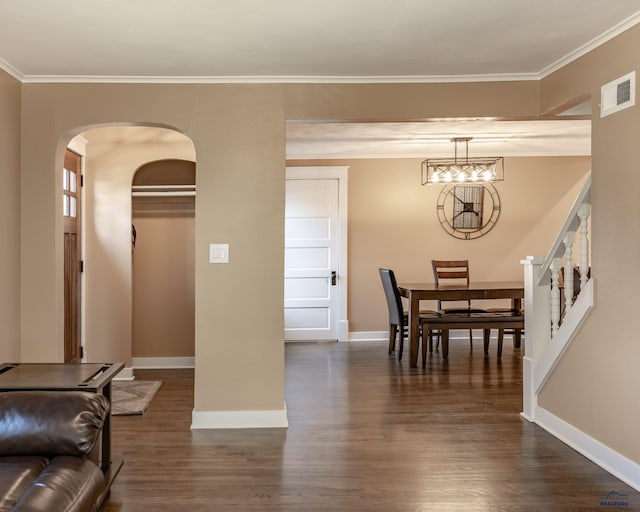 1316 Clark, Rapid City, SD 57701 - dining space featuring baseboards, dark wood-type flooring, arched walkways, ornamental molding, and stairs