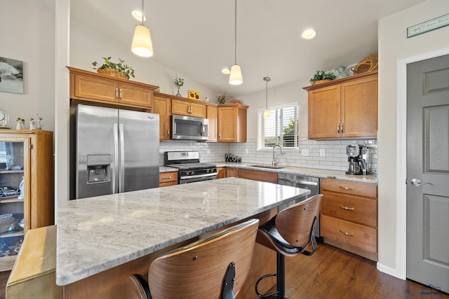 3511 Jerusalem Blvd, Rapid City, SD 57703 - kitchen featuring stainless steel appliances, a sink, backsplash, dark wood-style floors, and light stone countertops
