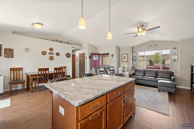 3511 Jerusalem Blvd, Rapid City, SD 57703 - kitchen featuring vaulted ceiling, ceiling fan, brown cabinetry, open floor plan, and a center island