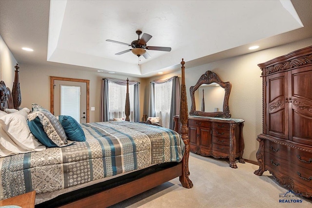 11916 Aspen View Rd, Sturgis, SD 57785 - bedroom featuring a raised ceiling, light colored carpet, recessed lighting, and a ceiling fan