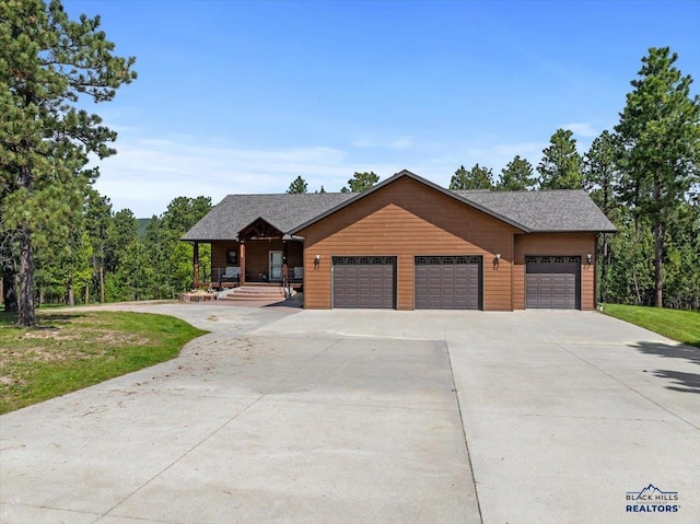 11916 Aspen View Rd, Sturgis, SD 57785 - rustic home with a garage, driveway, a porch, and a front yard
