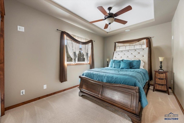 11916 Aspen View Rd, Sturgis, SD 57785 - carpeted bedroom featuring a raised ceiling, baseboards, and ceiling fan