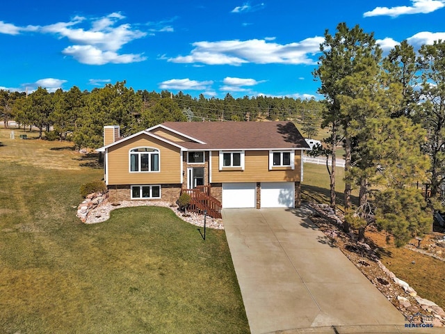 5588 Barberry Cir, Rapid City, SD 57702 - bi-level home featuring a garage, a chimney, driveway, and a front lawn