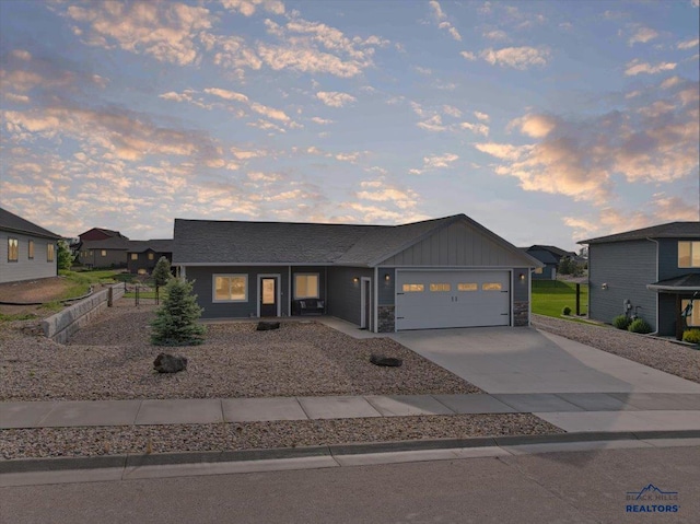 3781 W Beartooth Loop, Spearfish, SD 57783 - modern home with concrete driveway, an attached garage, and board and batten siding