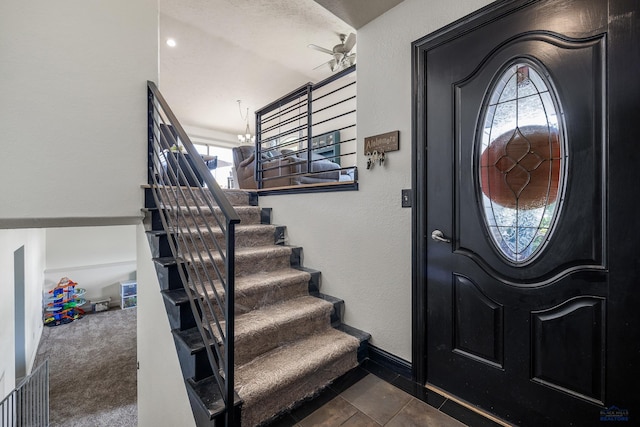 2909 Hoefer Ave, Rapid City, SD 57701 - foyer entrance featuring stairs, a ceiling fan, and a textured wall