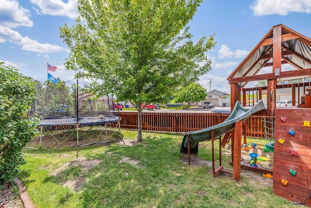 2909 Hoefer Ave, Rapid City, SD 57701 - fenced backyard featuring a trampoline and a playground