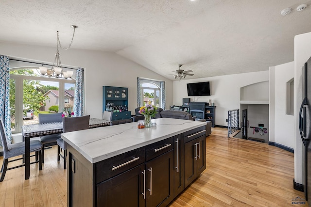 2909 Hoefer Ave, Rapid City, SD 57701 - kitchen featuring a textured ceiling, a chandelier, light wood finished floors, ceiling fan, and decorative light fixtures