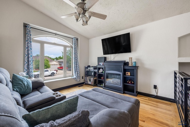 2909 Hoefer Ave, Rapid City, SD 57701 - living room with a textured ceiling, vaulted ceiling, a ceiling fan, and wood finished floors