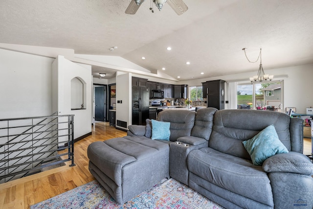 2909 Hoefer Ave, Rapid City, SD 57701 - living area featuring vaulted ceiling, light wood-type flooring, a textured ceiling, recessed lighting, and a chandelier
