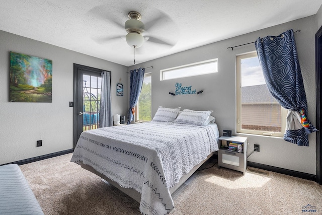 2909 Hoefer Ave, Rapid City, SD 57701 - bedroom with carpet floors, access to exterior, ceiling fan, and a textured ceiling