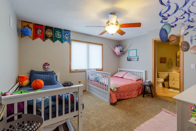 4941 Springtree Ct, Rapid City, SD 57702 - carpeted bedroom featuring ensuite bath, a textured ceiling, and a ceiling fan
