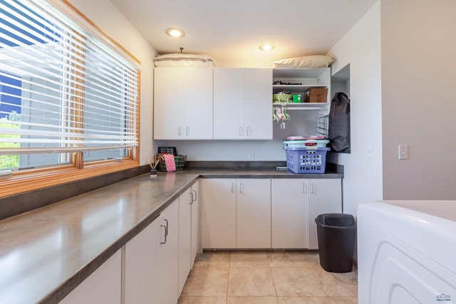 4941 Springtree Ct, Rapid City, SD 57702 - kitchen with plenty of natural light, white cabinets, and separate washer and dryer