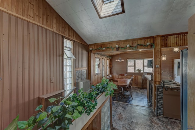 12525 Jax Ct, Rapid City, SD 57701 - dining room with wood walls, a skylight, and lofted ceiling