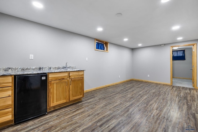 113 E Custer St, Rapid City, SD 57701 - kitchen featuring fridge, dark wood-style floors, recessed lighting, light stone countertops, and brown cabinets