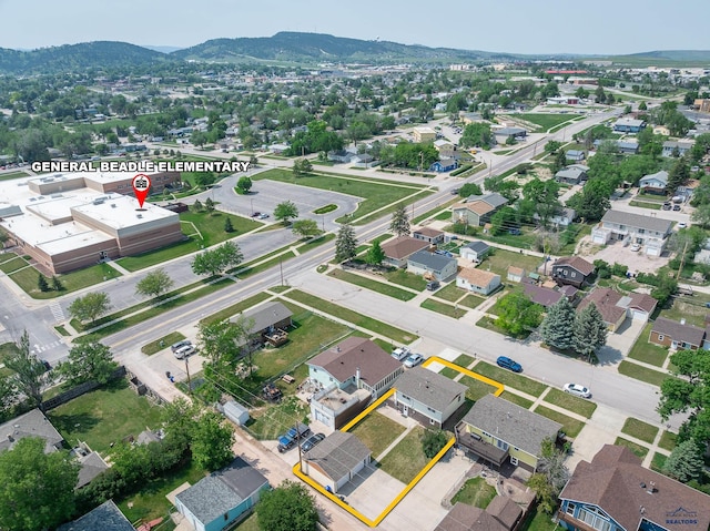 113 E Custer St, Rapid City, SD 57701 - aerial view of property and surrounding area featuring property parcel outlined, a mountain backdrop, and nearby suburban area