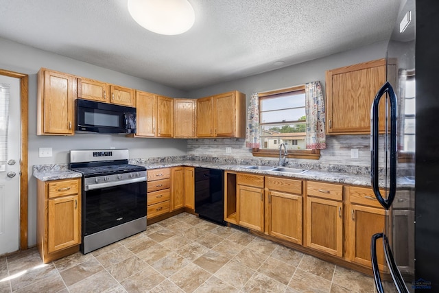 113 E Custer St, Rapid City, SD 57701 - kitchen featuring black appliances, stone finish floors, a textured ceiling, and light stone counters
