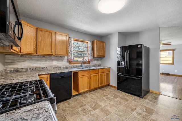 113 E Custer St, Rapid City, SD 57701 - kitchen featuring black appliances, decorative backsplash, a textured ceiling, brown cabinetry, and ceiling fan