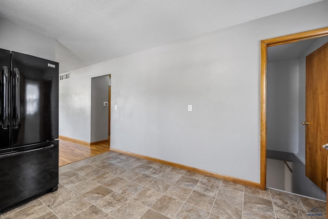 113 E Custer St, Rapid City, SD 57701 - unfurnished room featuring stone finish flooring and a textured ceiling