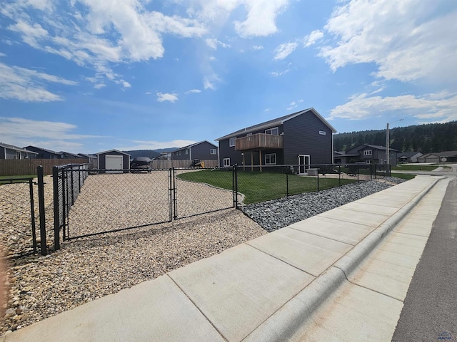 3408 Davenport Loop, Sturgis, SD 57785 - view of property exterior featuring a garage, a residential view, a gate, driveway, and an outdoor structure