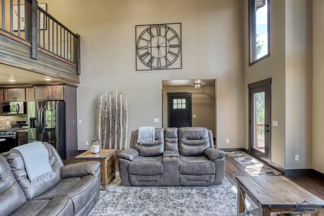 20746 Monte Carlo Rd, Lead, SD 57754 - living room featuring a towering ceiling, healthy amount of natural light, and wood finished floors