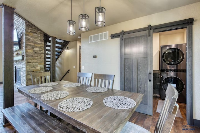 20746 Monte Carlo Rd, Lead, SD 57754 - dining room with stacked washer / drying machine, a barn door, dark wood-style floors, and stairway