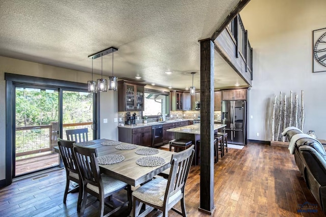 20746 Monte Carlo Rd, Lead, SD 57754 - dining space with dark wood-style flooring, plenty of natural light, and a textured ceiling