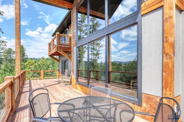 20746 Monte Carlo Rd, Lead, SD 57754 - unfurnished sunroom with a high ceiling and wood-type flooring