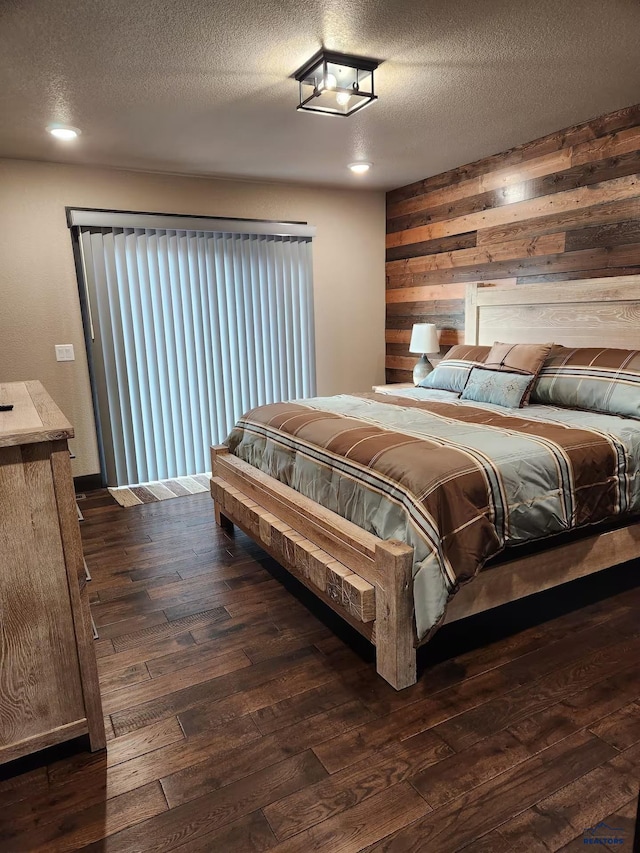 20746 Monte Carlo Rd, Lead, SD 57754 - bedroom featuring wood walls, dark wood-type flooring, and a textured ceiling