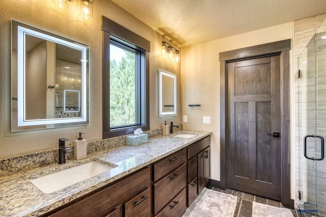 20746 Monte Carlo Rd, Lead, SD 57754 - bathroom with a textured wall, double vanity, a textured ceiling, and a shower stall