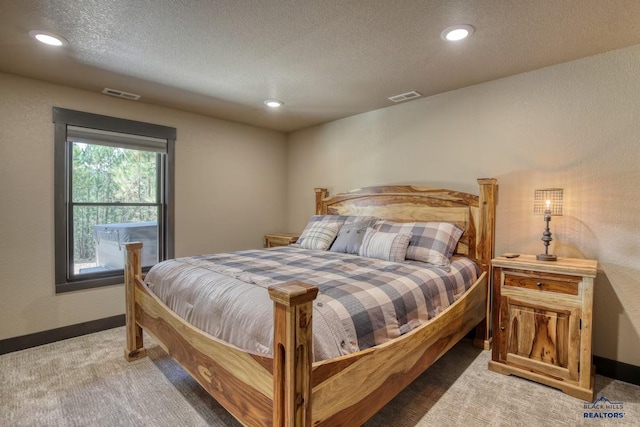 20746 Monte Carlo Rd, Lead, SD 57754 - bedroom with light colored carpet, a textured ceiling, and recessed lighting