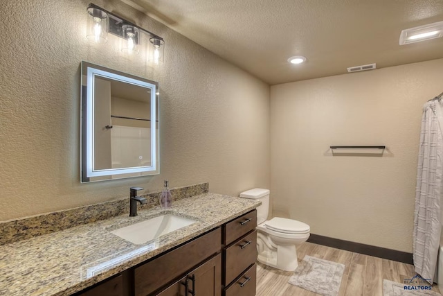 20746 Monte Carlo Rd, Lead, SD 57754 - full bath with wood finished floors, vanity, a textured wall, and curtained shower