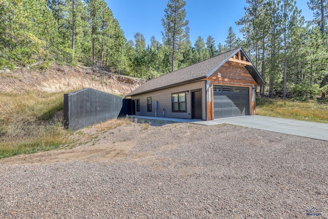 20746 Monte Carlo Rd, Lead, SD 57754 - view of front facade featuring a garage, driveway, and roof with shingles